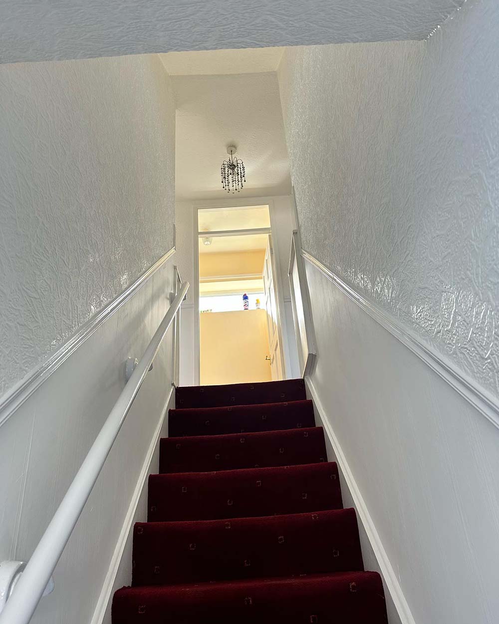 stairway of a house after being sprayed white