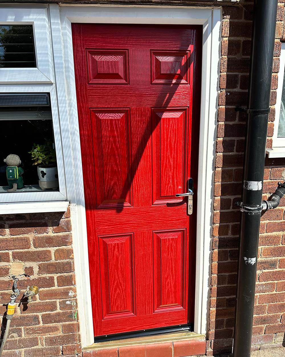 Old fashioned, red front door with white frame